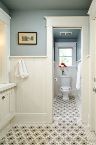 wainscoting and tile bathro