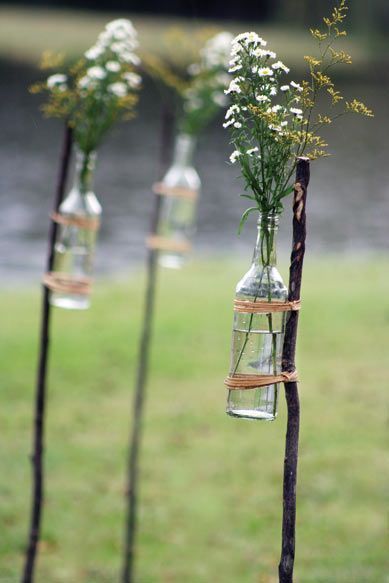 old bottles strapped to fallen branches + queen annes lace snippets – great aisle or path markers. Dont like the very rugged look. but good idea for using bottled