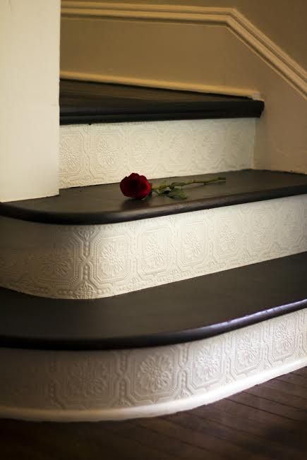 Add paintable and textured wallpaper on the stair risers – great DIY project, and affordable – under $30!