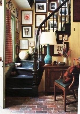 I love how the pictures are large and hang there! I even like the brick floor! Perfect for my English Cottage! :)