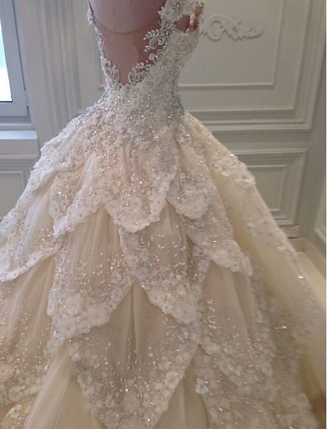 I normally hate most wedding dresses, but this is unique and stunning. I can only imagine this dress down the Isle in a dimmed
