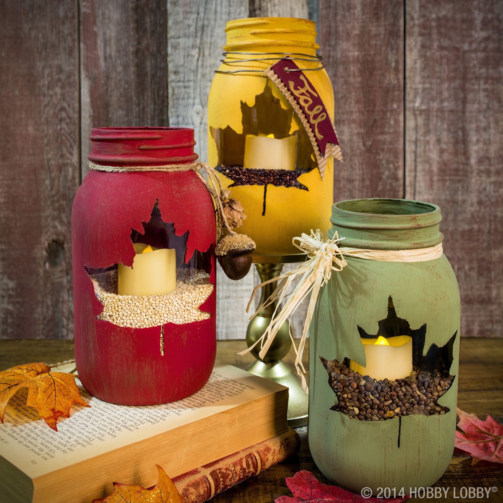 Stencil out leaf design before painting mason jars with chalk paint. This peek-a-boo craft is sure to please your Thanksgiving