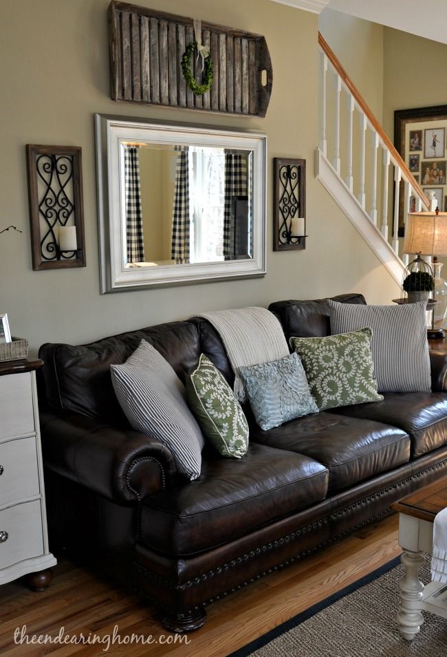 Adding a mirror above the sofa is a great way to create the sense of space in a living room