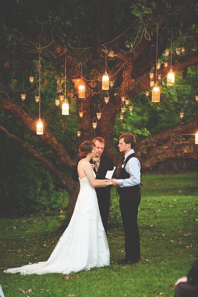 Candles hanging from the trees while you recite your vows = so romantic | Credit: Steven Michael Photo