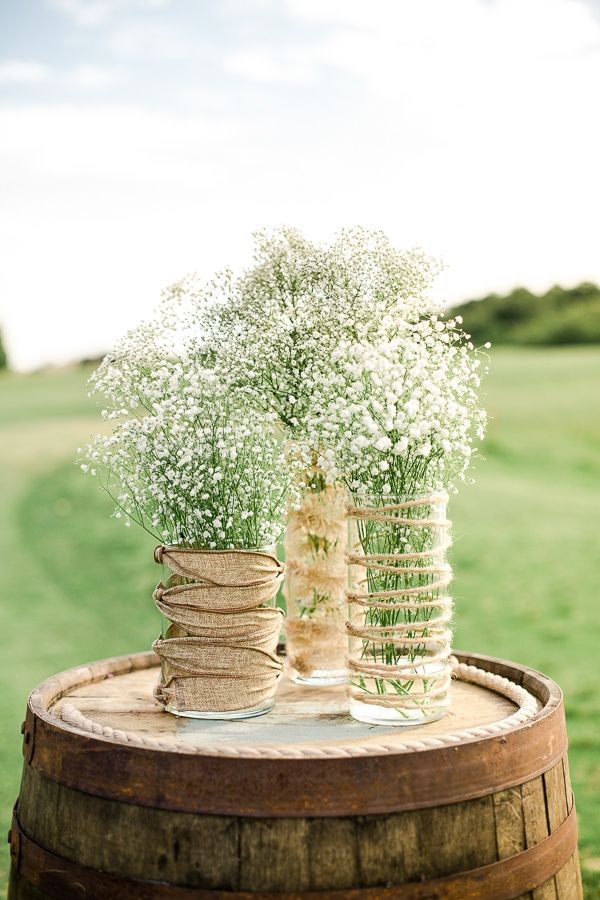 Dress up mason jars or vases with some burlap and twine. I like the way the twine is wrapped around the vases.