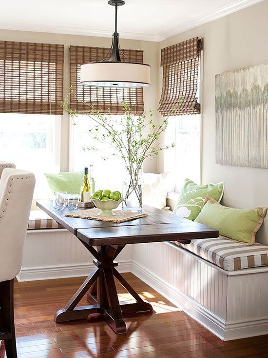 Farmhouse dining table with pedestal base for breakfast nook that has a banquette bench