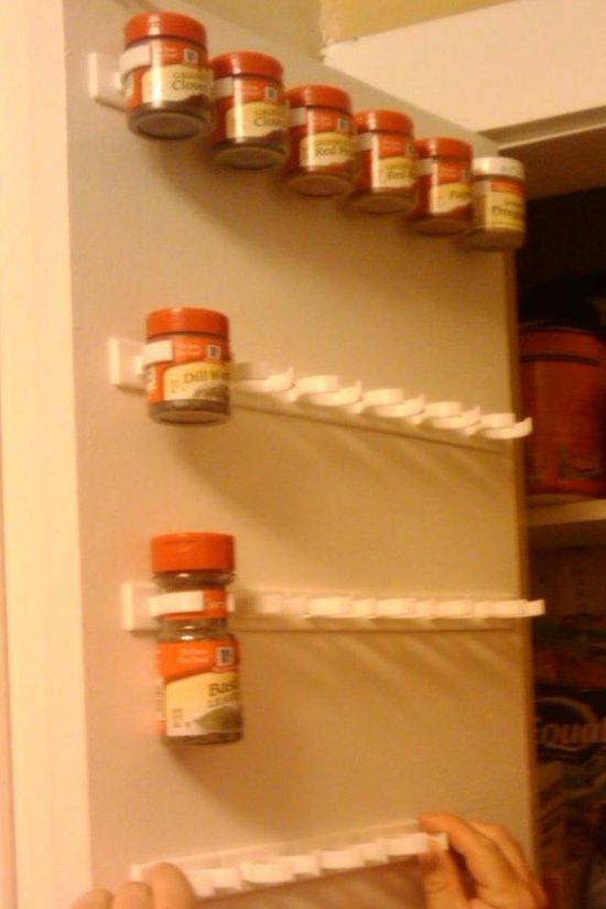 Forget the spice rack!!  Use a mop holder to store spices on the inside of a cabinet door. (no more searching through the deep