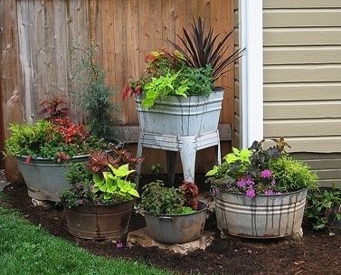 I like these wash tubs as planters. What a neat garden display.