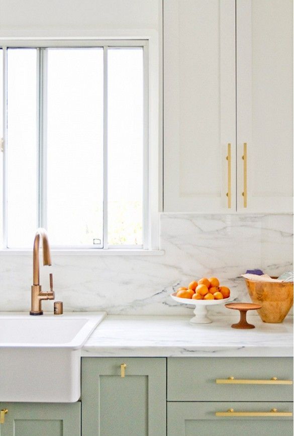 In this Los Angeles home, semi-custom cabinetry with rich brass hardware harmonizes with an IKEA sink and faucet to create a