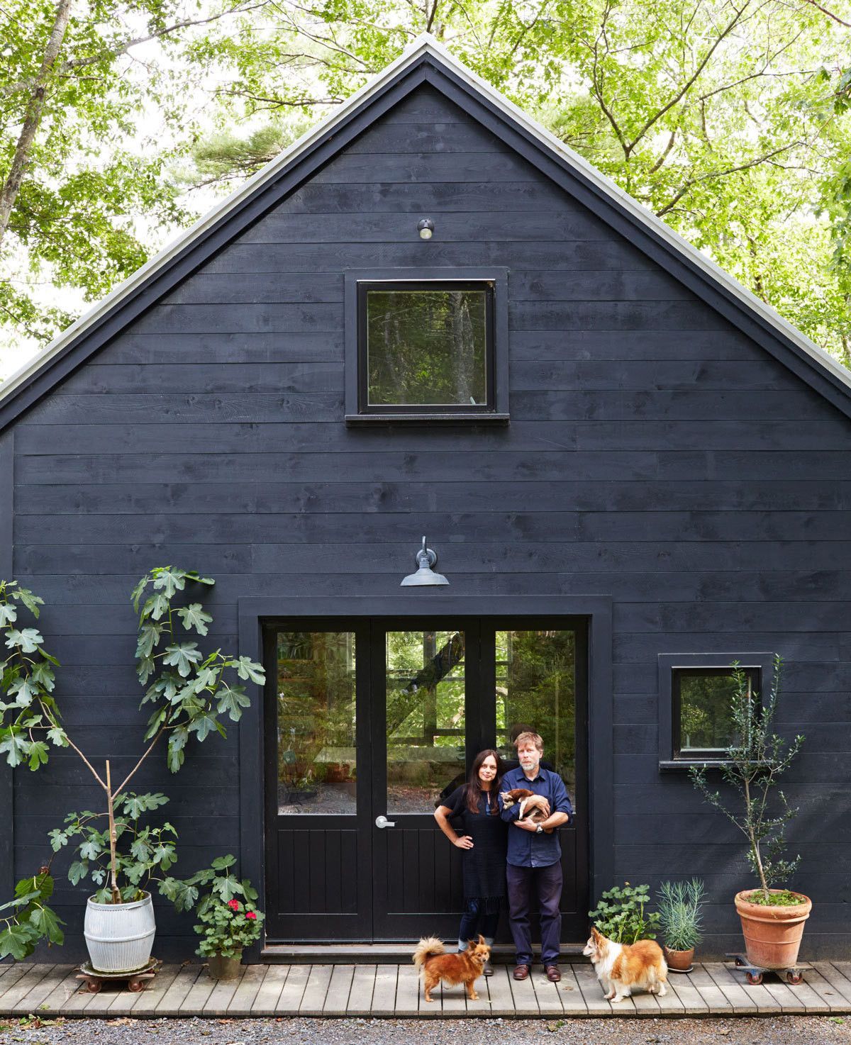 Michele Michael and Patrick Moore in front of the barn they built at their home in Dresden, Maine.