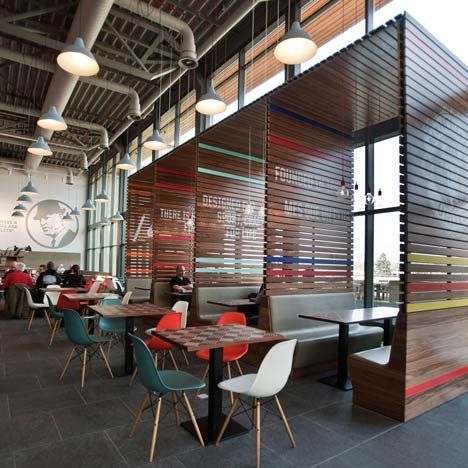 Nike Office (Netherlands)
Design Studio:  UXUS
Dining area with slatted booths adorned with painted logos