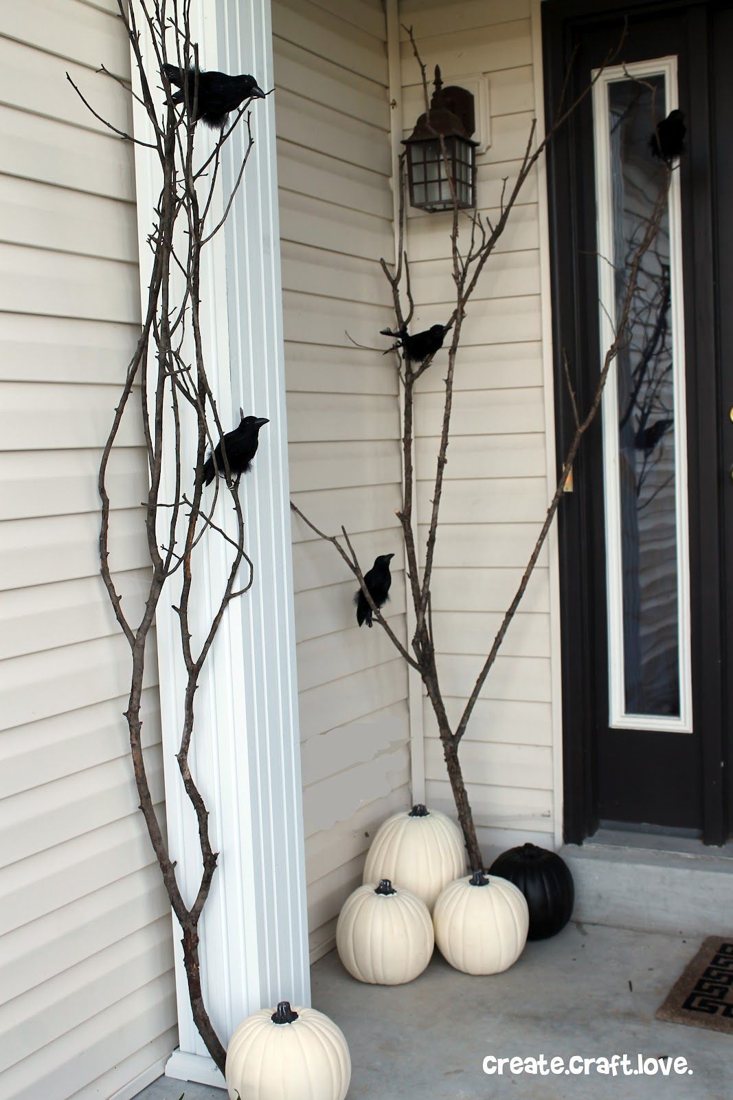 Paint some pumpkins white, some branches black, add plastic ravens and voila, a very cool Halloween porch!