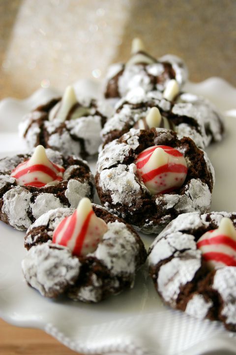 these brownie like thumbprint cookies can be made with any type of kiss! Author shows them with white chocolate, peppermint,