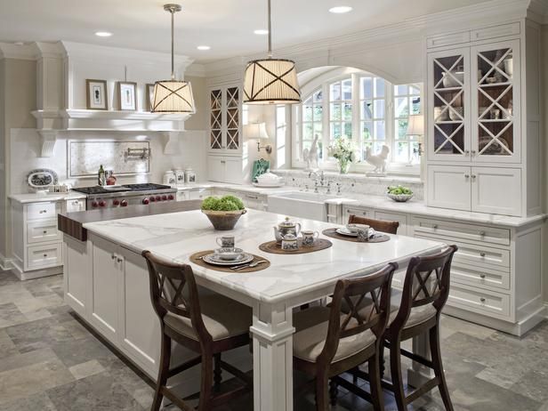 This kitchen island serves double-duty with ample work spaces and formal seating.