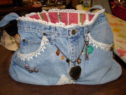 tote purse made from old denim blue jeans and found trinkets and bits of lace and vintage fabrics.