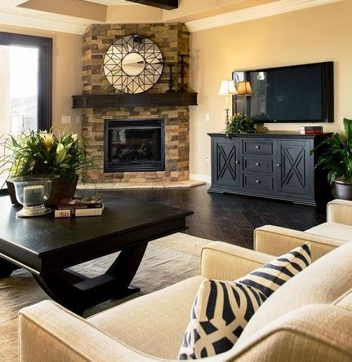 We love this living room setup with its nice, warm colors and gorgeous fireplace. We would, however, have to move the lamp so that