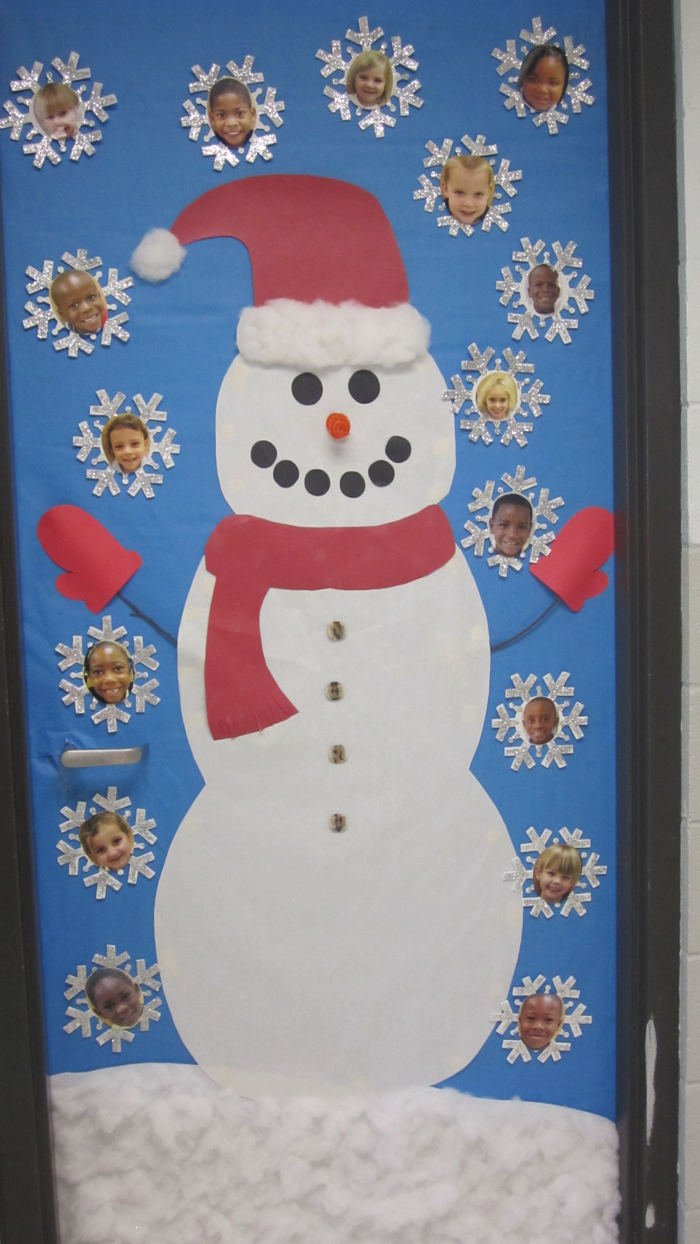 A very cute Frosty the Snowman classroom door display that includes snowflakes with students face in the middle of them.