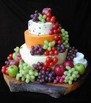 Cheese wheel and grape “cake” would be perfect for a wine tasting party!