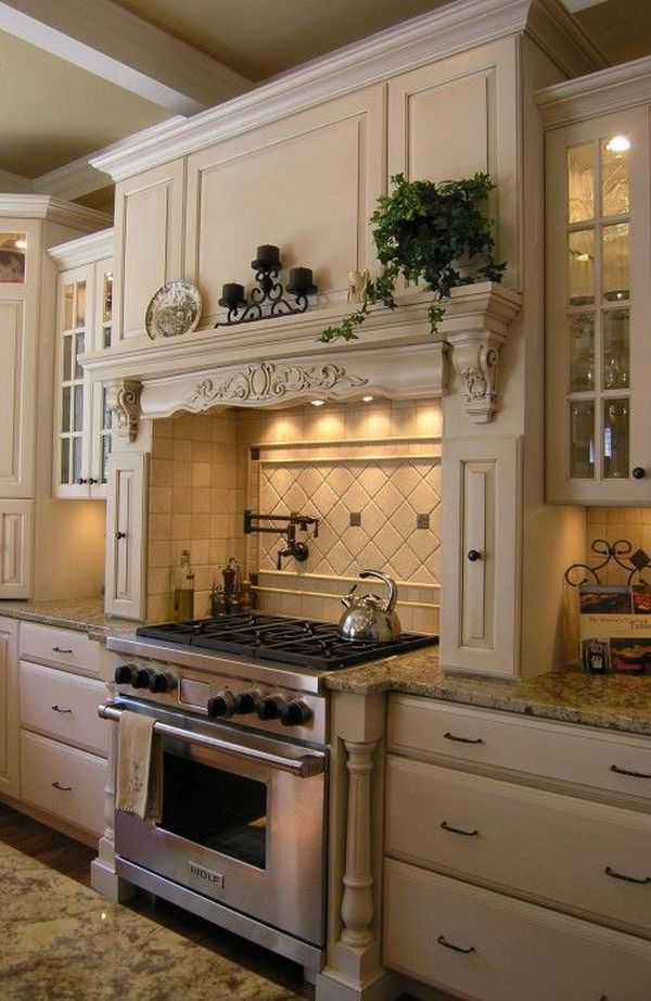 Cooking area with faux mantel in a richly decorated French country kitchen