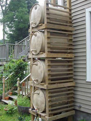Multiple rain barrels stacked for higher water pressure (& greater storage volume)