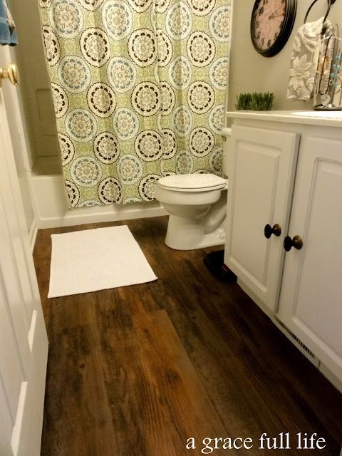 plank wood vinyl flooring!  $50 for the whole room…sweet! plus i really like the look of the bathroom