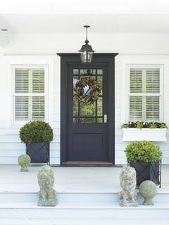 White & Navy :: Dark Navy Front Door. With a yellow flowered wreath or yellow flowers in the planters.