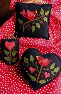 A beautiful pair of Wool Applique pin cushions and scissors case in rich shades of felted wool.  Applique these designs with #8