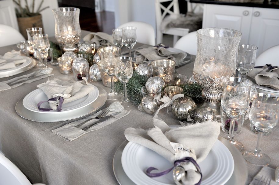 A beautiful table set for winter entertaining in shades of greys, silver, and purples.