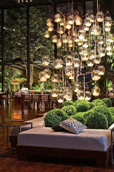 Awesome candle chandelier in lounge area of event.  Also love the cluster of shrubberies in between the benches.