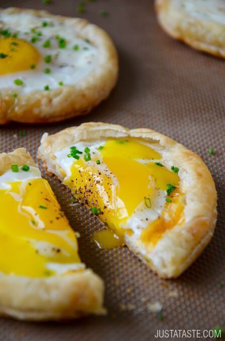 Cheesy Puff Pastry Baked Eggs  – Store-bought puff pastry, eggs, cheddar cheese and chives. The eggs are cooked directly in