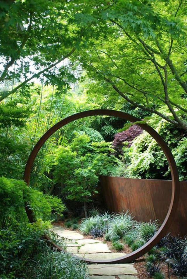 For a zen influence, divide your garden into two sections by installing a circular opening or “moongate” onto a fence or trellis.