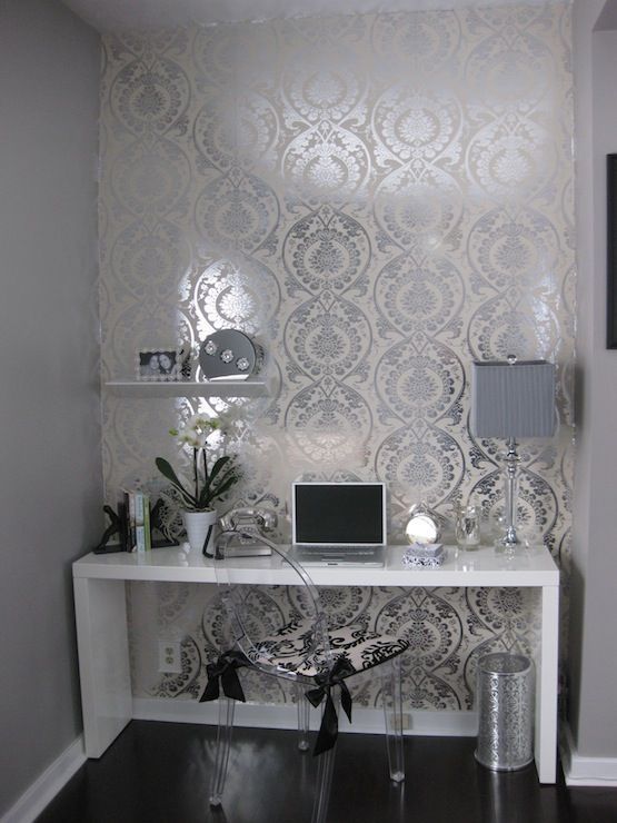 I love this concept for a desk or vanity area. Patterned foil accent wall, white desk, crystal lamp, orchid arrangement, ghost