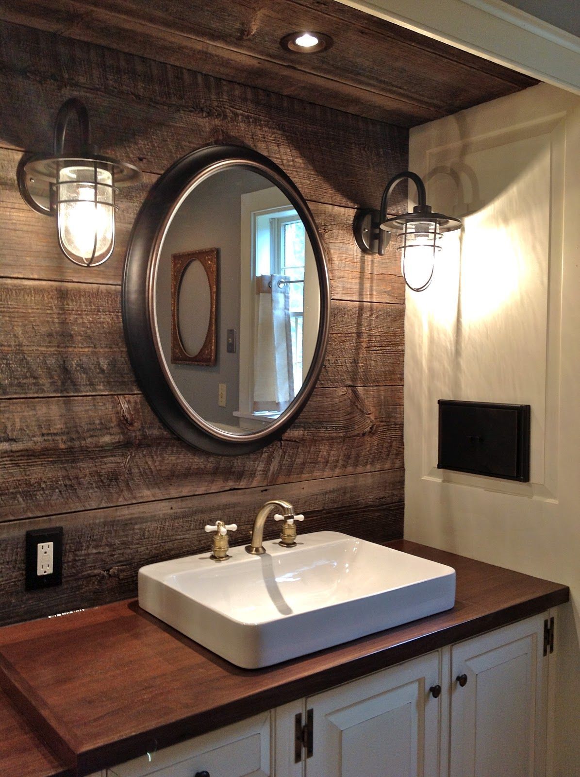 Round mirrors, industrial lighting, reclaimed barnwood, counter mounted sink, Peruvian walnut counter