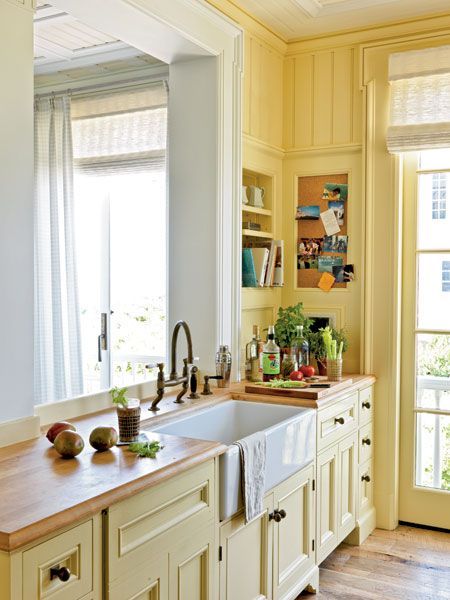 Butcher-block countertops add beach-cottage charm at a good price in this kitchen in Seaside, Florida. Buttery walls and cabinets