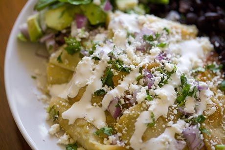 chilaquiles – fried corn tortillas, green sauce, topped with black beans, eggs and avocado – forgot the cilantro and cotija cheese