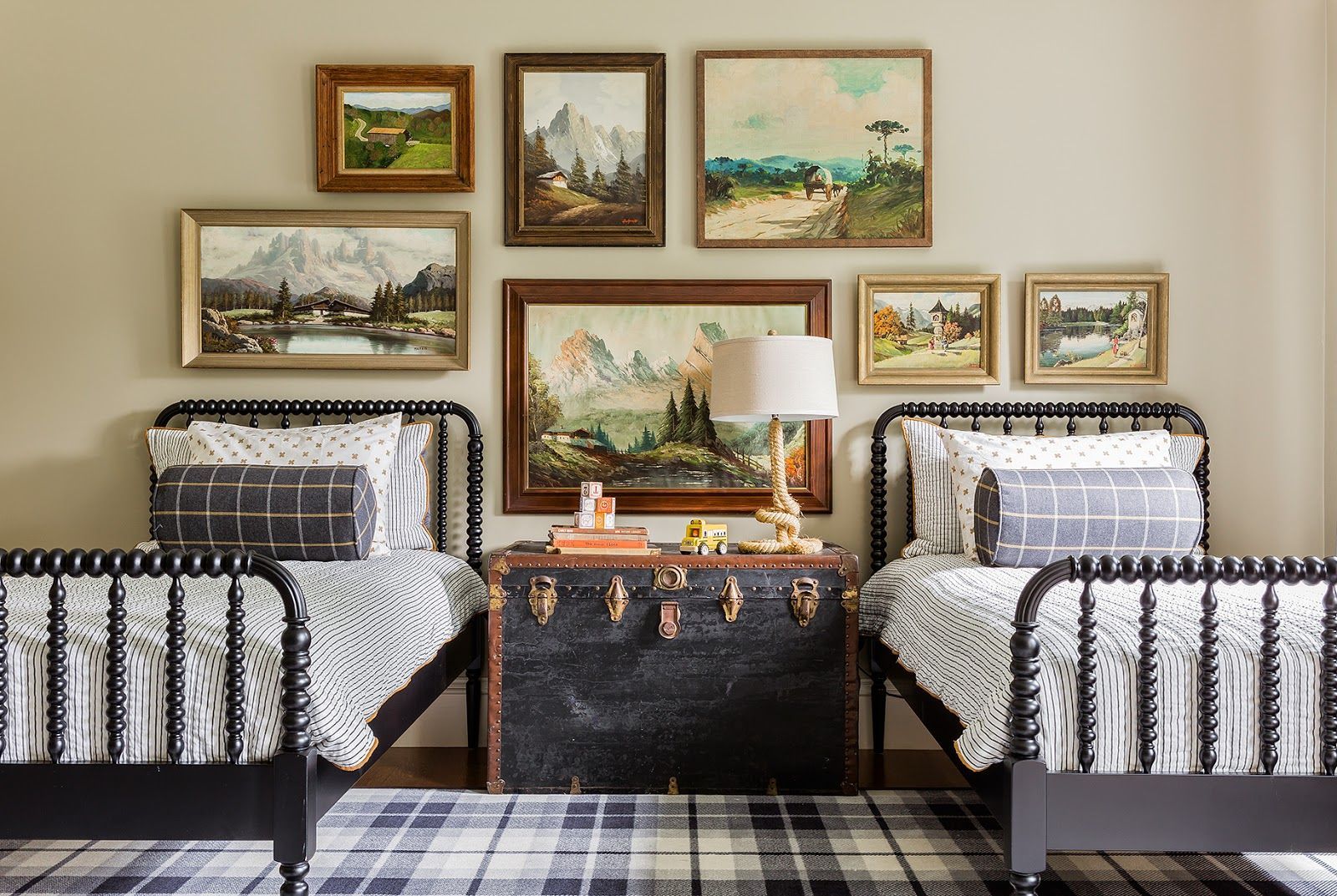 Cute room – love the Jenny Lind beds, trunk and plaid rug, swap the art for something more fun and its a great kids room!