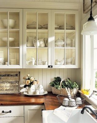 Love the glass open cupboards, with beadboarding splash… the wooden counters, the farmhouse sink. hmmm… everything really!