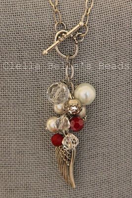 Love the trailing angel wing at the bottom of this cluster of beads and pearls, from cat-catscreations…