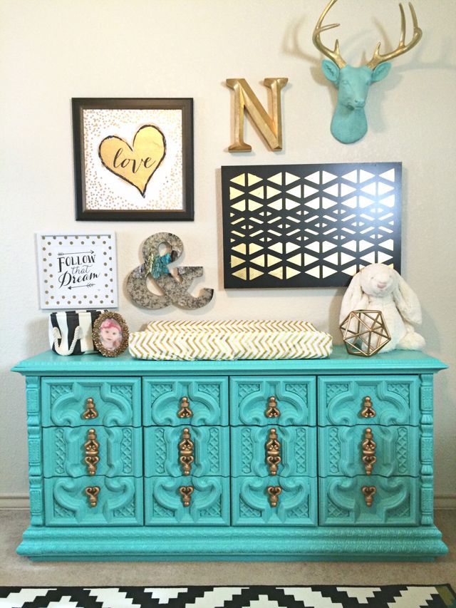 This vintage dresser painted aqua is a such a show-stopper in this black, white and gold nursery! LOVE.