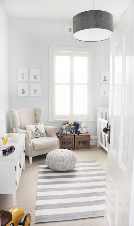 White and gray nursery features gray drum pendant, West Elm Short Drum Pendant, over white and gray stripe rug, CB2 Pull Up a Pouf