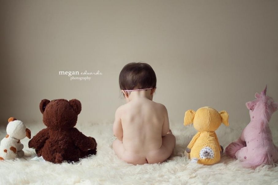 9 month baby pose…with all his stuffed animals and favorite toys