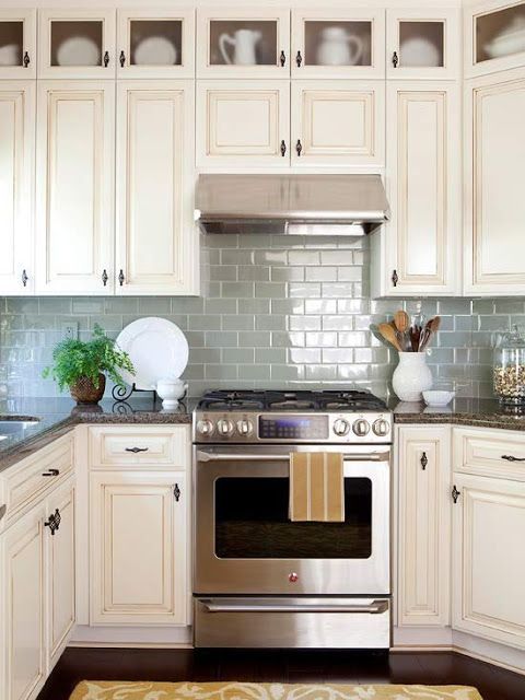 colored subway tile back splash and I love the open display windows on top of all the cabinets!!