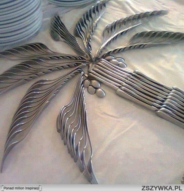 Creative cutlery arrangement for a party or buffet. Palm leaves are forks, knives form the trunk and overturned spoons give the