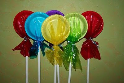 Cute idea. Paper plates, colorful cellophane, wooden dowels to make decorative lollipops for a party