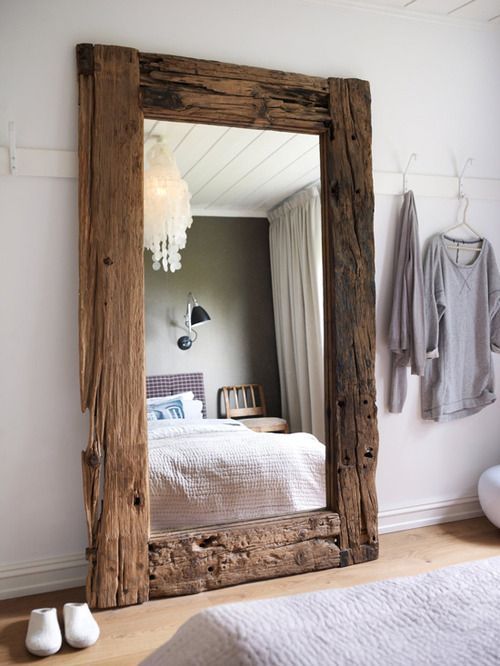 I like the idea of using a large mirror and a place to hang clothes to create a simple dressing area in the room.