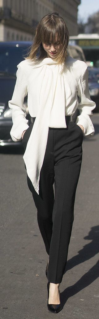 Paris Fashion Week street style:  Anya Ziourova wearing classic black pants and a white tie collar shirt paired with classic black