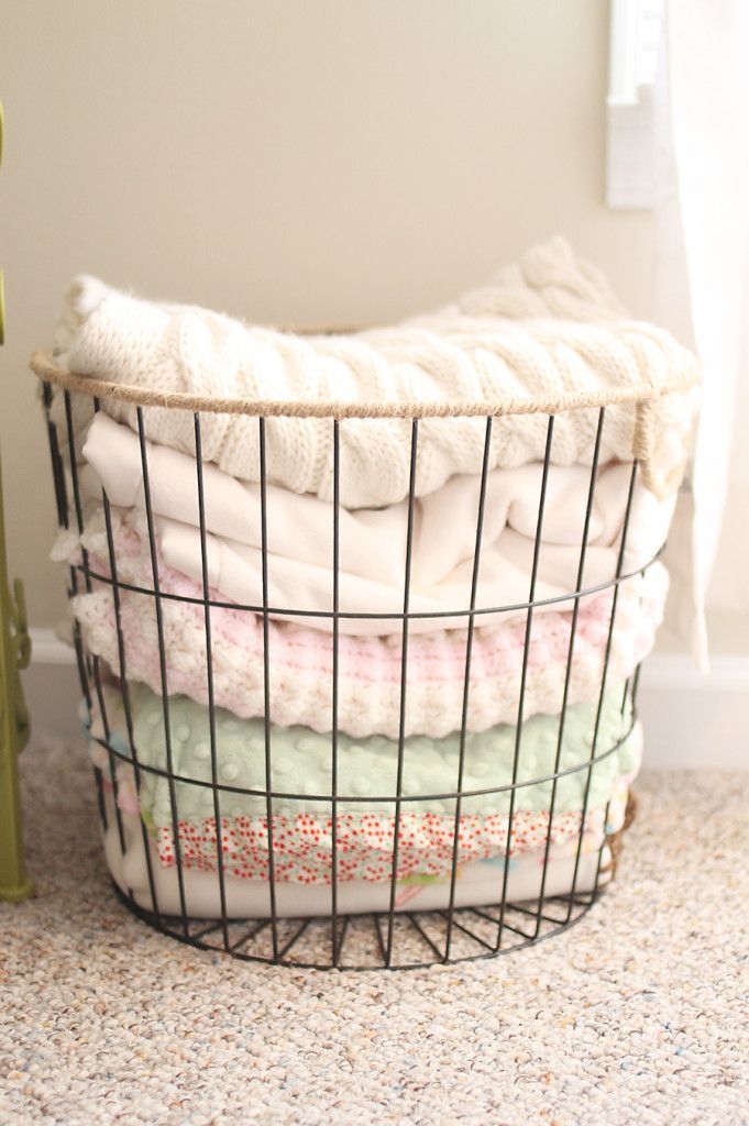 Project Nursery – WIRE BASKET FULL OF BABY BLANKETS, SITTING NEXT TO ROCKER