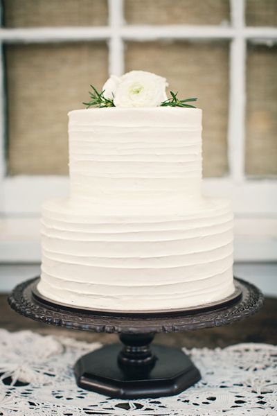 Simple white wedding cake with white flowers on top!