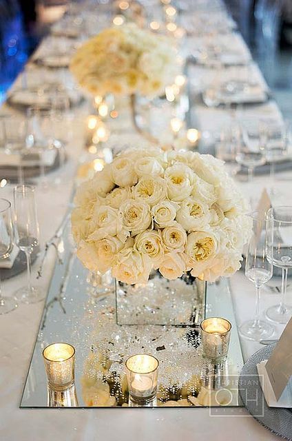 Some of the tables will have mirrored vases with white hydrangeas surrounded by silver mercury glass votives.