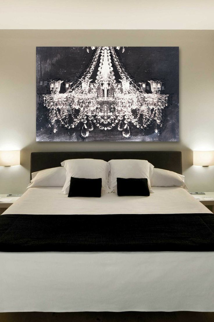 The chandelier art by Oliver Gal gives a romantic touch to this bedroom.